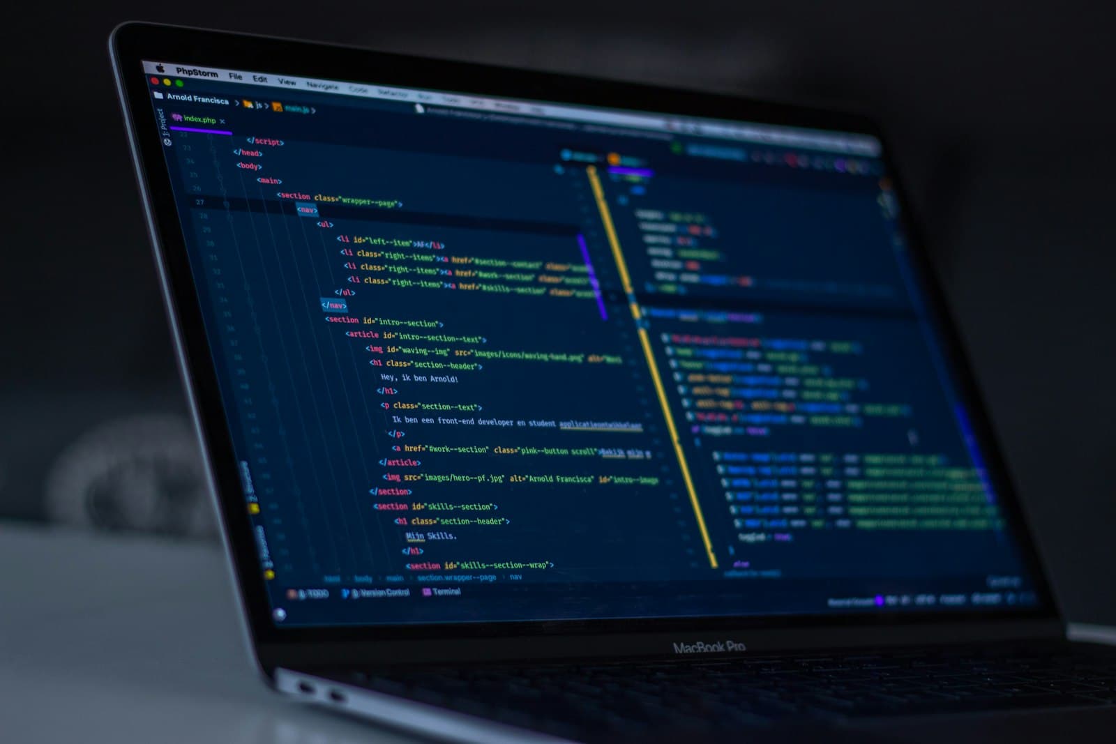 Developer working at a desk with code visible on a monitor